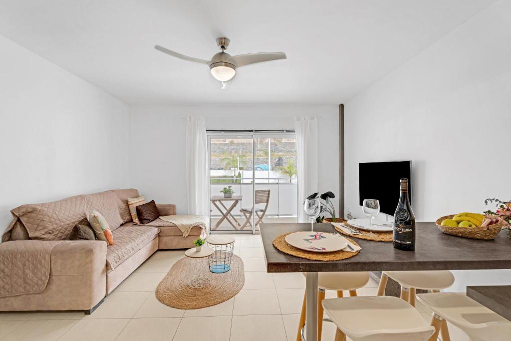 a living room with a couch and a table at Bajamar en armonía in Bajamar