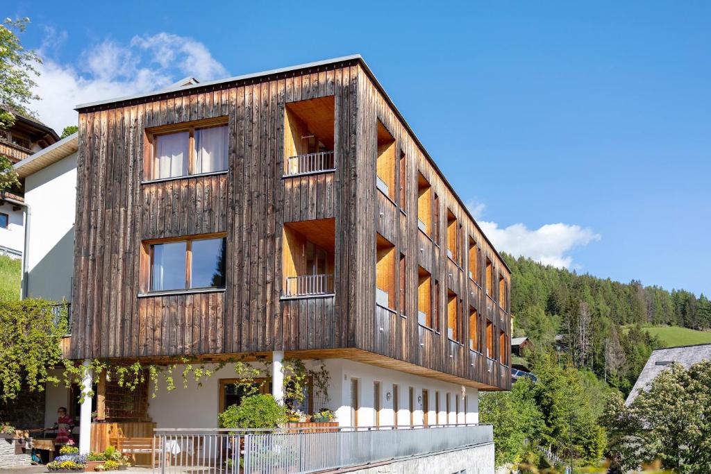 a timber clad house with a wooden facade at Al Cargá San Vigilio di Marebbe in San Vigilio Di Marebbe