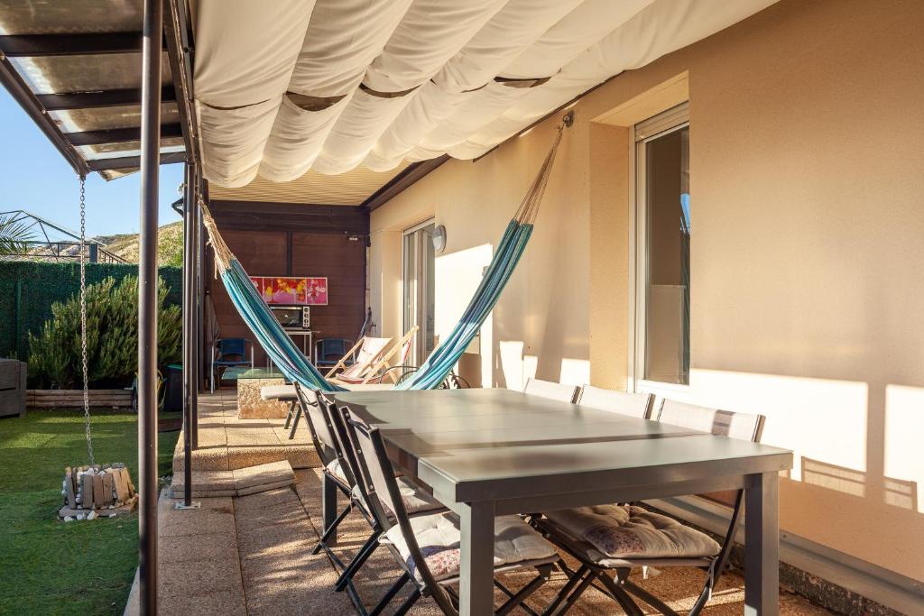 a patio with a table and chairs under awning at Appartement Evasion in Marseille