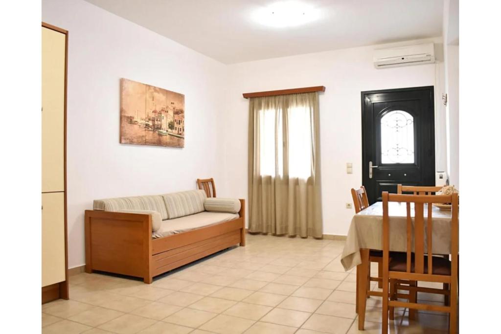a living room with a couch and a table at Manolika Studio 3 in Kithnos