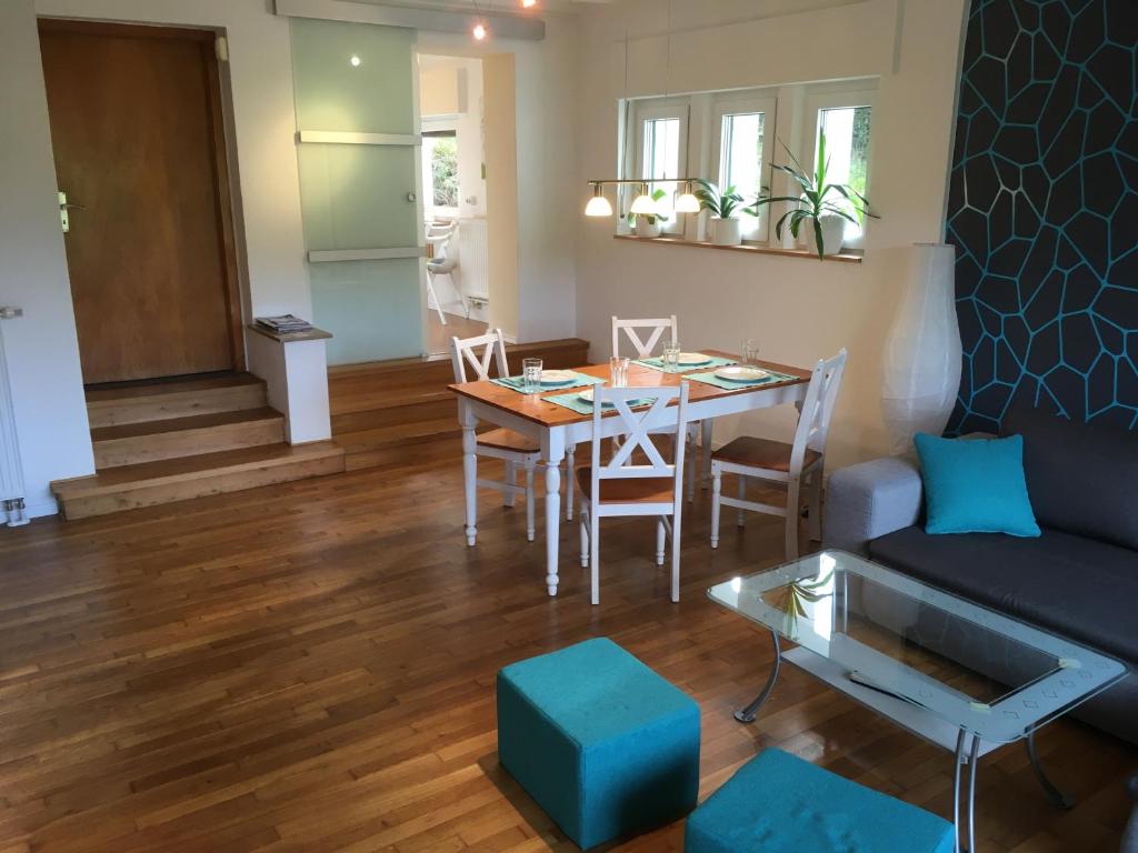 a living room with a table and a couch at Ferienwohnung Am Sieperloh in Stryck