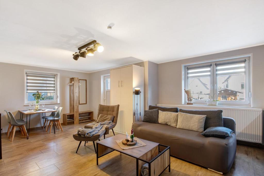 a living room with a couch and a table at Ferienwohnung Andreas in Naumburg