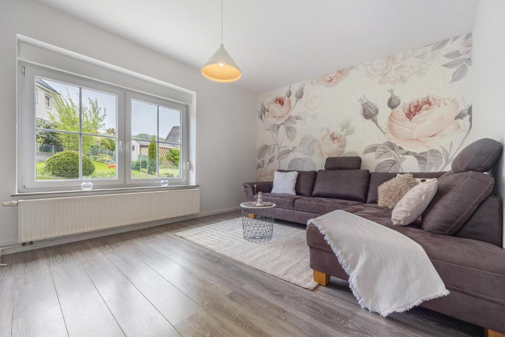 a living room with a couch and a window at Haus am Garten in Brunkensen