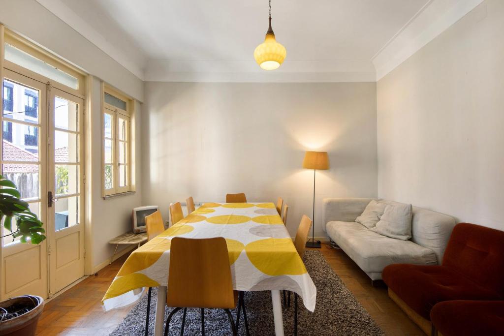 a living room with a table and a couch at A Casa Formosa in Porto