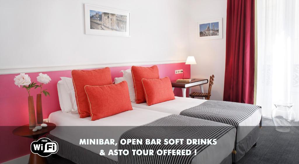 a hotel room with a bed with red pillows at Hotel Monterosa - Astotel in Paris