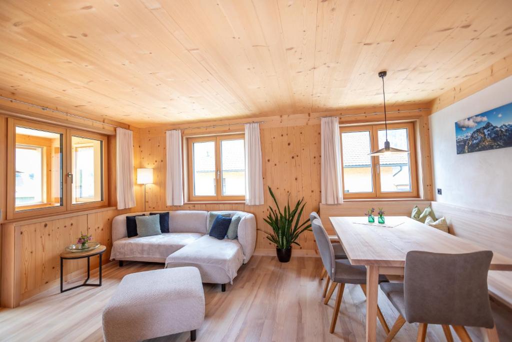 a living room with a couch and a table at Haus Hoalp in Au