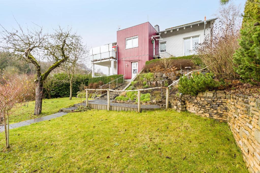 a house with a garden in front of it at Ferienwohnung am Schmenkenberg in Marsberg