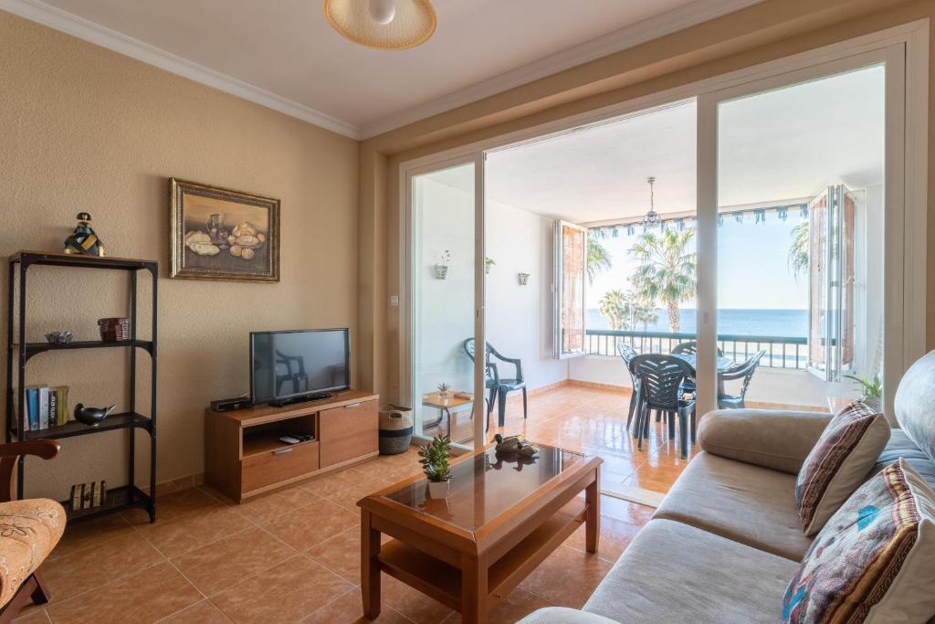 a living room with a couch and a tv at Beautiful duplex in Salobreña in Salobreña