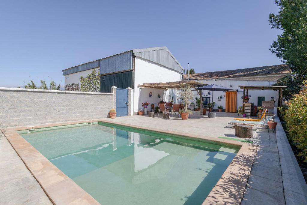a swimming pool in the backyard of a house at Casa Encarnacion in Granada