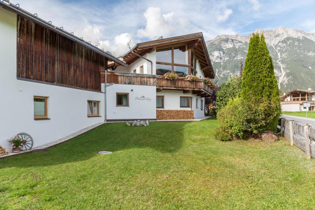 an external view of a house with a yard at Panorama Lodge Leutasch mit Sauna in Leutasch