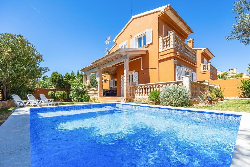 a house with a swimming pool in front of a house at Villa Amelia cerca de cala Pi in Llucmajor