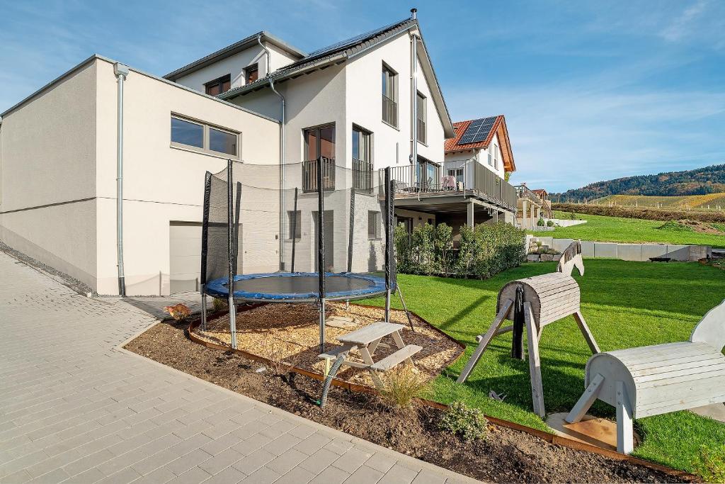 a house with a playground in front of it at Ferienwohnung am Tanzberg in Oberkirch