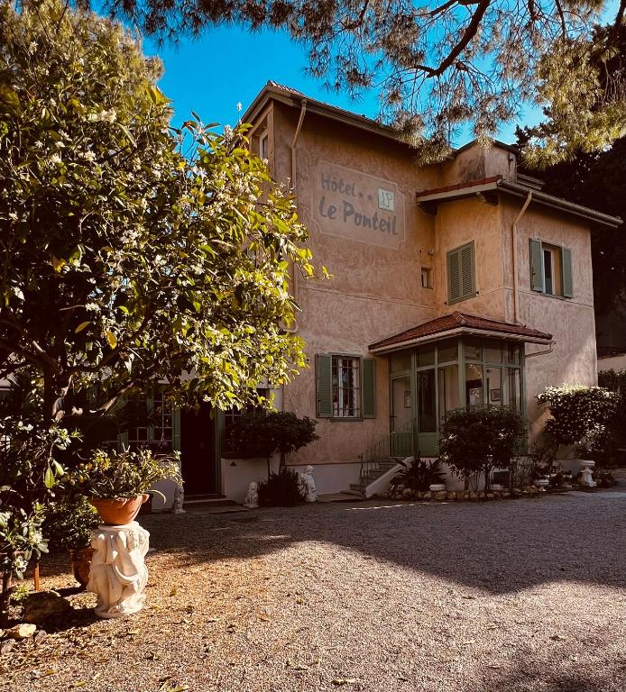 a building with a vase in front of it at Hotel Le Ponteil in Antibes