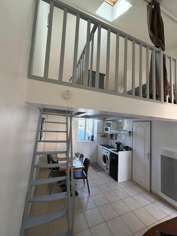 a staircase leading up to a living room with a kitchen at L'échoppe Rochelaise in La Rochelle