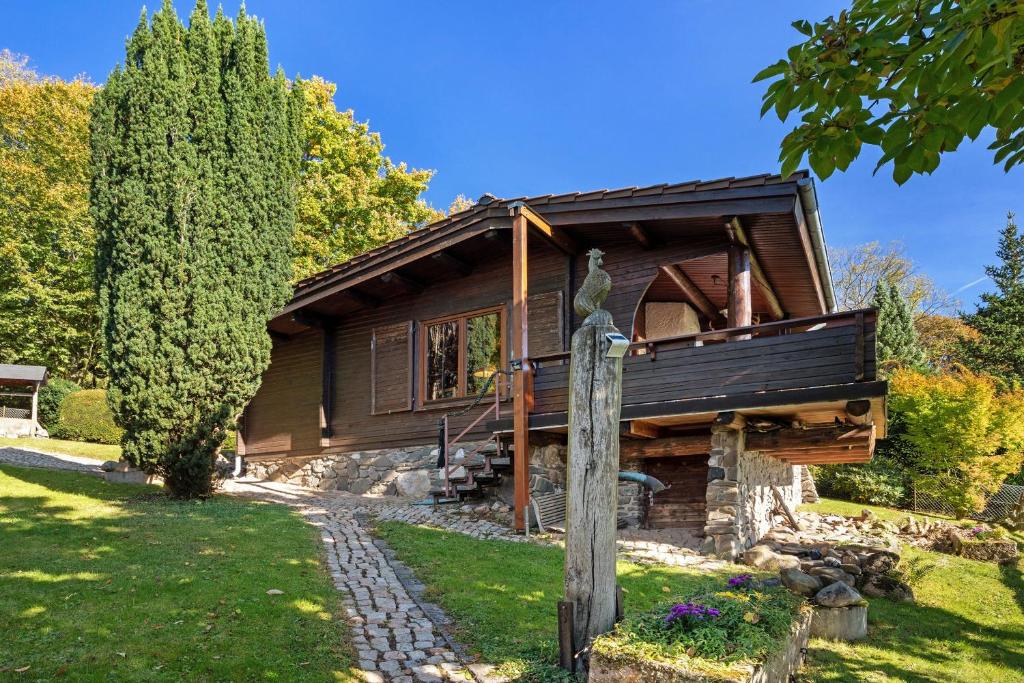 a wooden house with a statue in front of it at Haus-am-Harz Bad Gandersheim in Bad Gandersheim