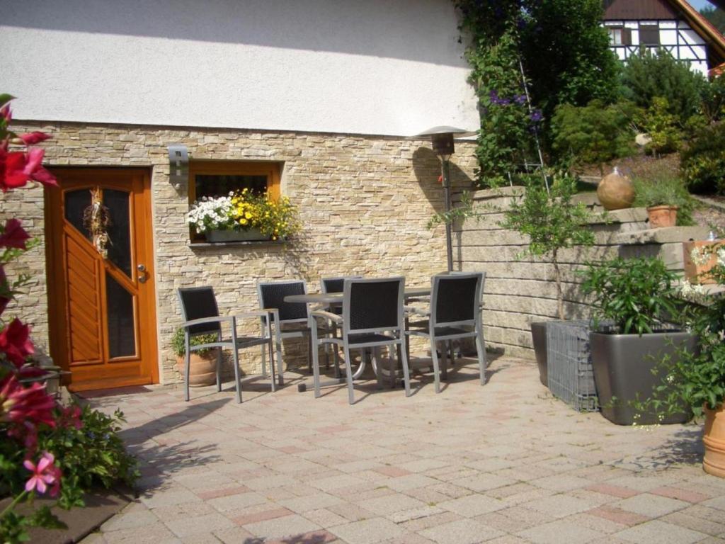 a group of chairs sitting in front of a building at Wohnung mit Terasse im Schwarzwald in Seebach