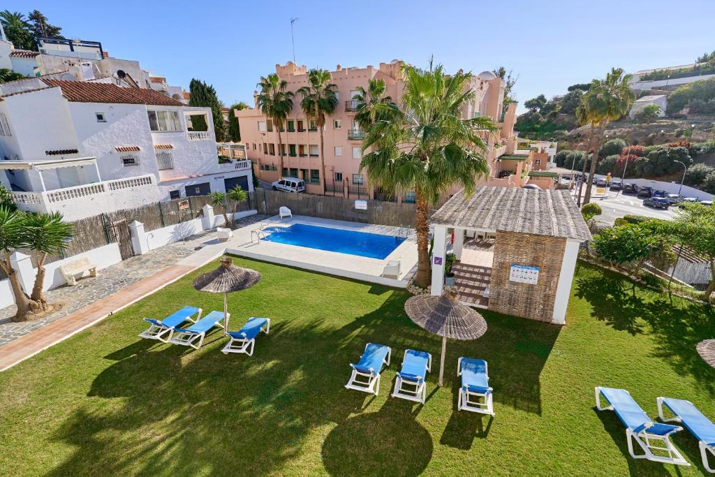 an aerial view of a yard with chairs and a swimming pool at Nerja Vacaciones Apartamentos in Nerja