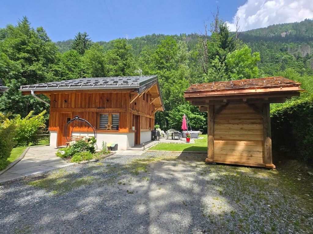 a wooden building with a gate and a shed at Chalet Pierre d Anatase in Saint-Gervais-les-Bains