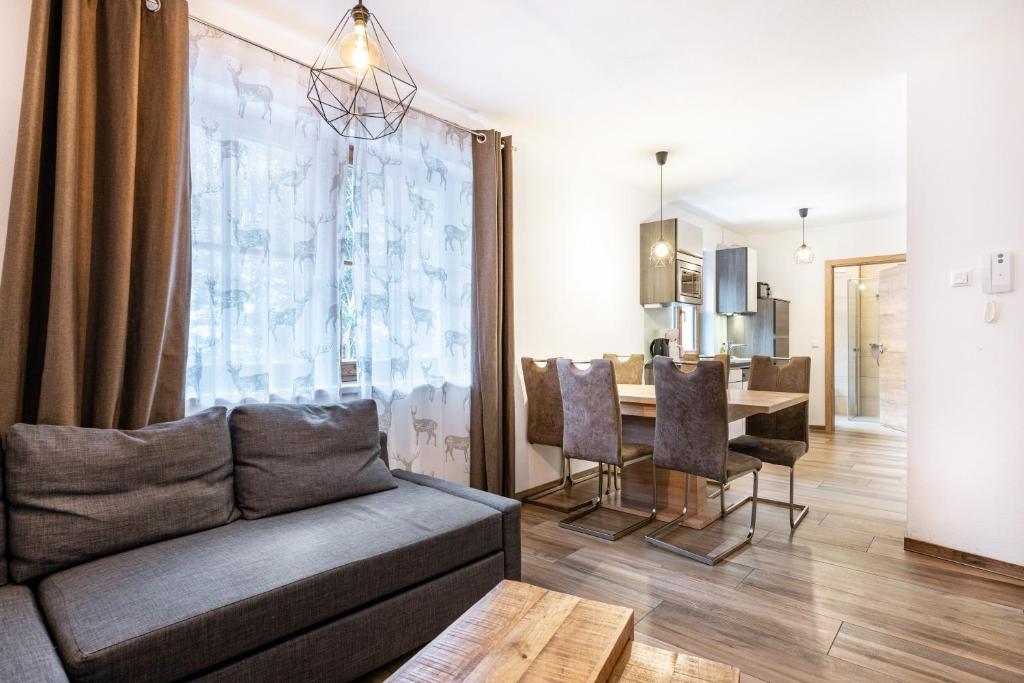 a living room with a couch and a table at Goodlife Top 1 in Saalbach-Hinterglemm