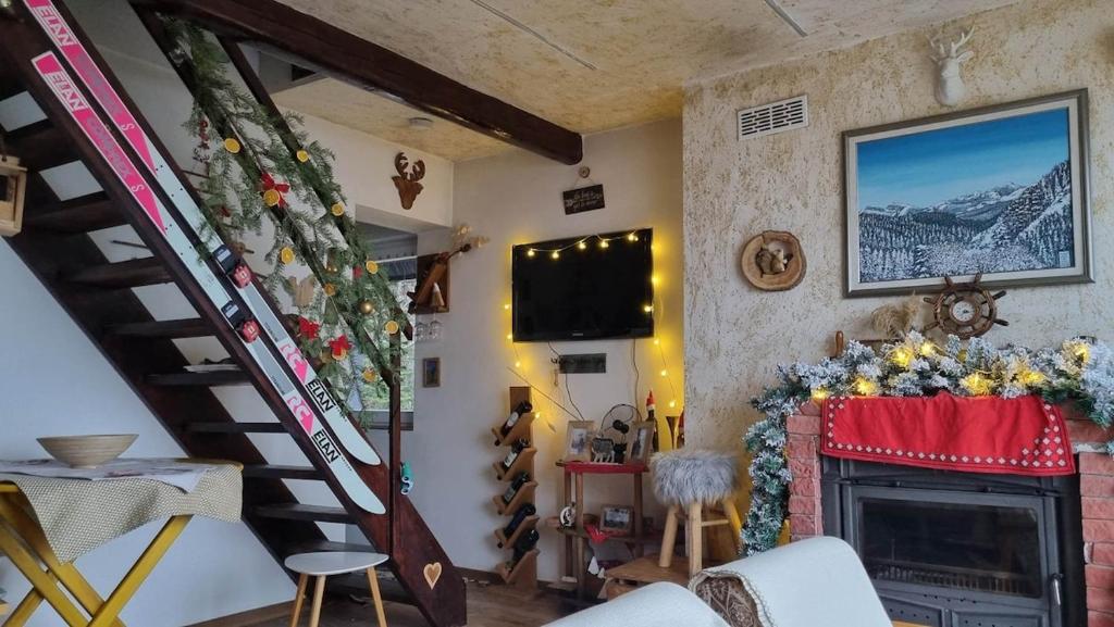 a living room with a staircase and a fireplace at Villa Freddie Mavrovo - Lakeview House in Mavrovo