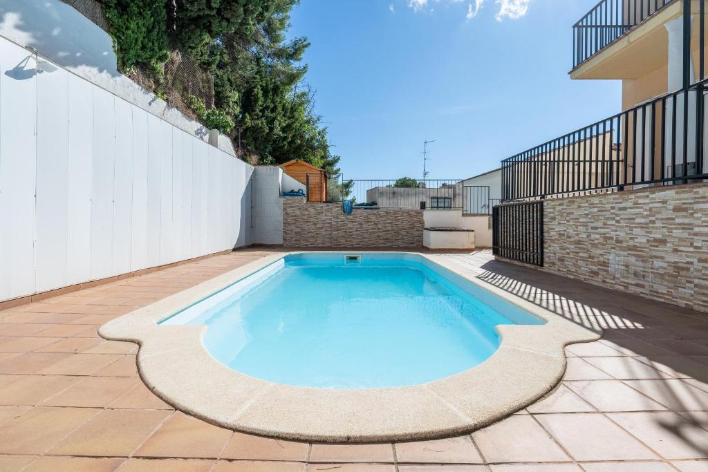 a swimming pool in the middle of a patio at Dorada Apartment Sol in Calafell