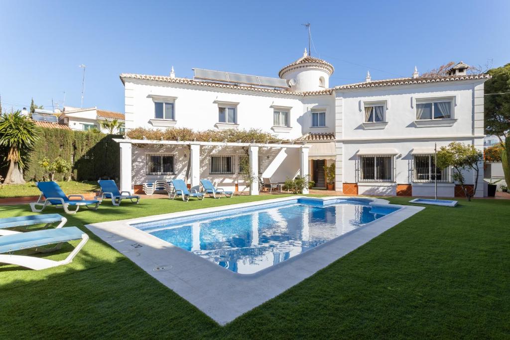 a large house with a swimming pool in the yard at Villa Eden Nerja in Nerja