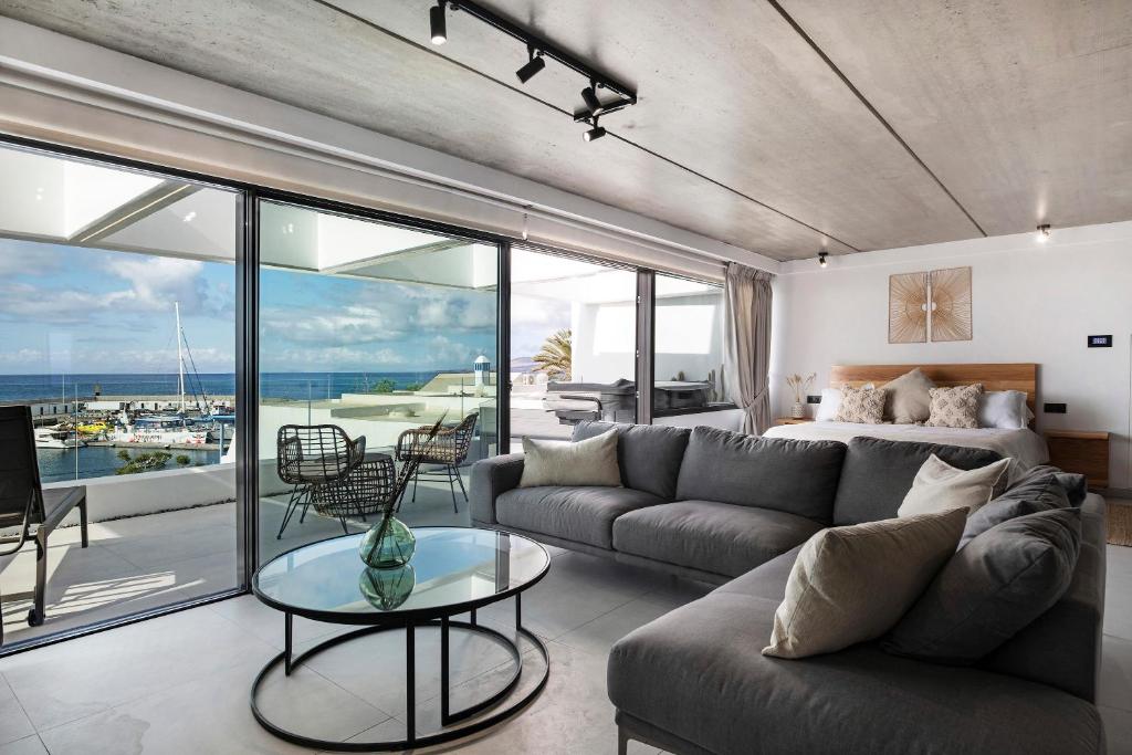 a living room with a couch and a view of the ocean at Gran Suite Horizonte in Puerto del Carmen