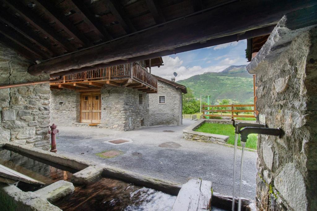 a building with a fire hydrant in front of it at Petite Maison des Alpes in Morgex