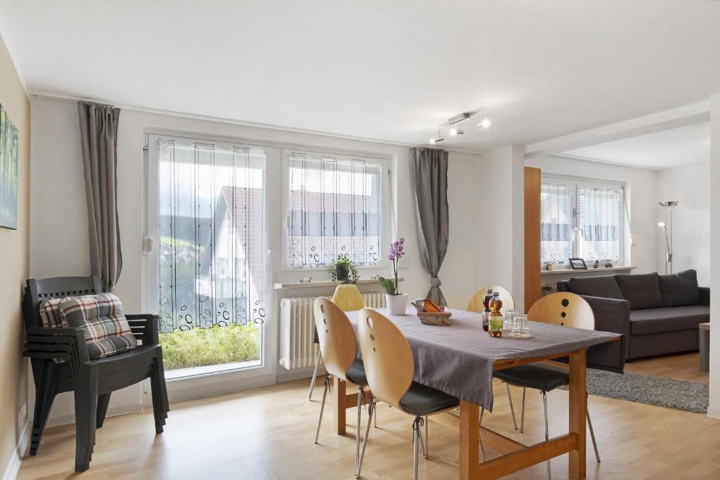 a living room with a table and chairs and a couch at Ferienwohnung Windradblick in Schonach