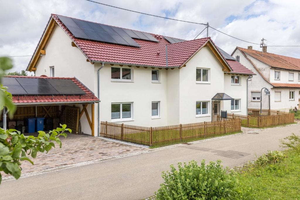 a house with solar panels on the roof at Ferienwohnung "Haus Kellenburg" in Albstadt