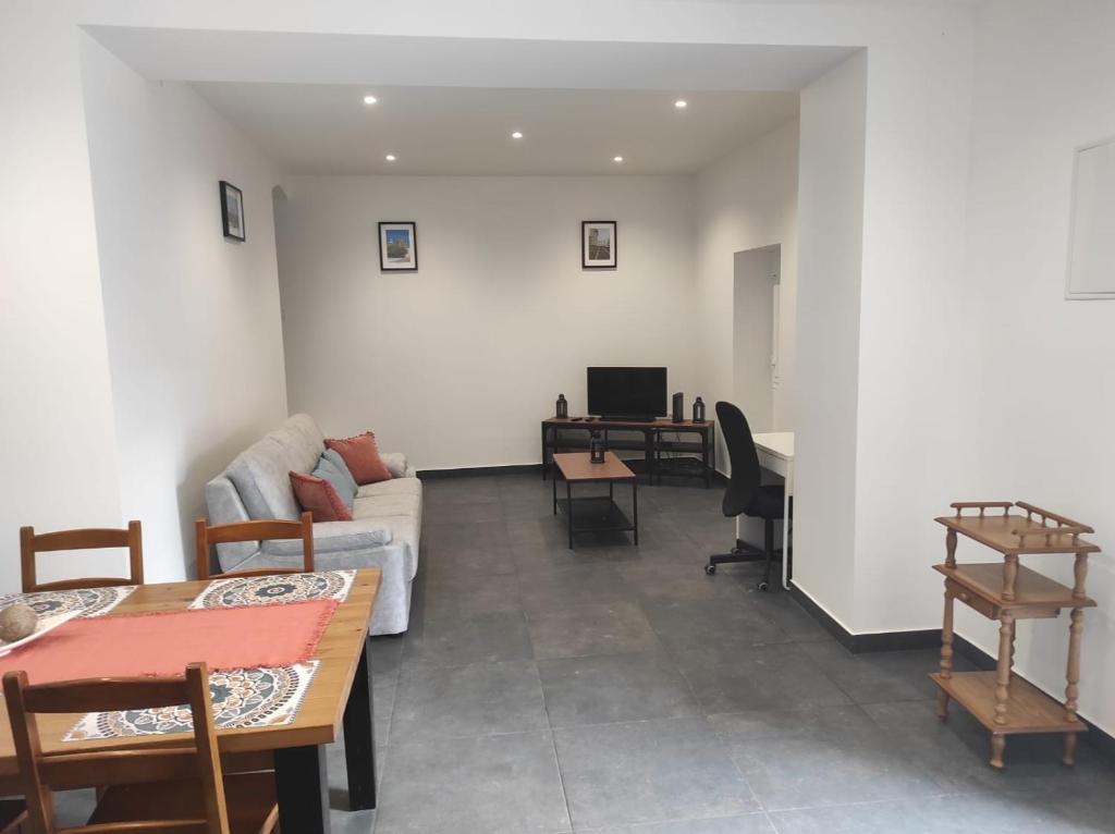 a living room with a couch and a table at Casa da Mina in Mina do Bugalho