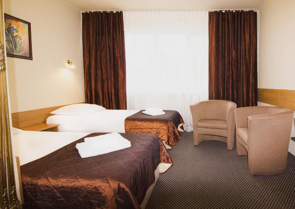 Posteľ alebo postele v izbe v ubytovaní HotelsLublin