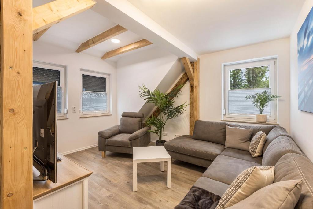 a living room with a couch and a tv at Fewo Landblick Geiseltal in Braunsbedra