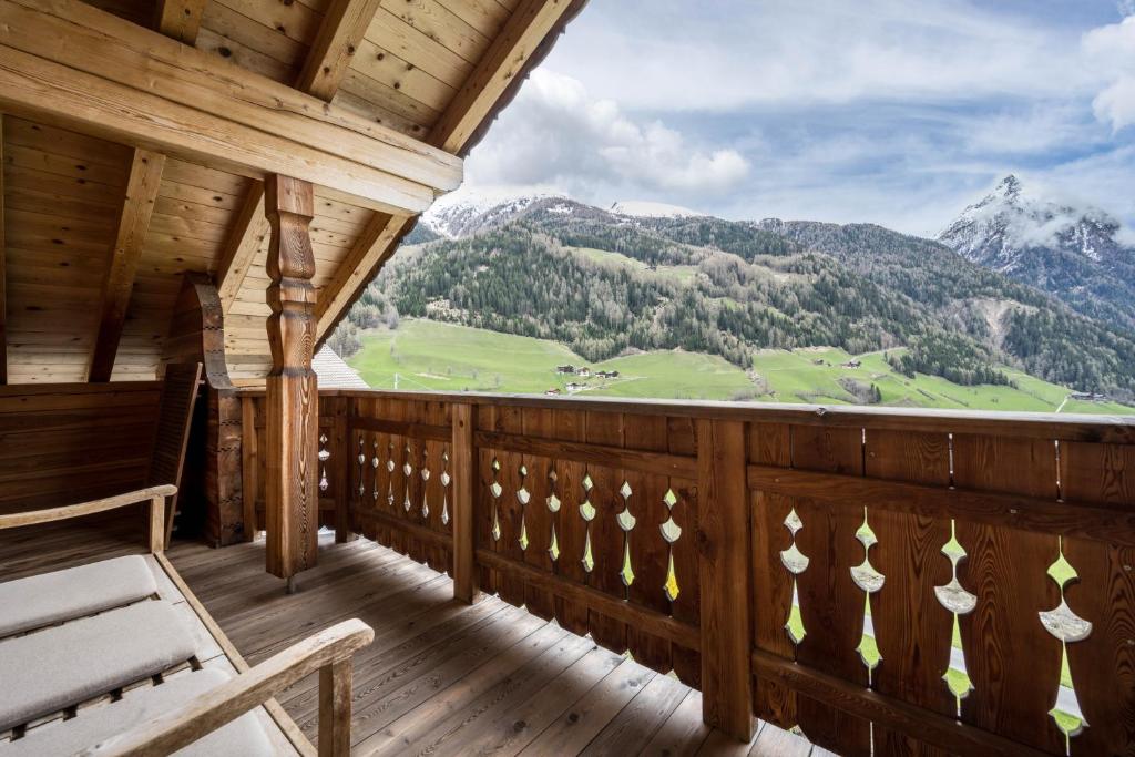 a room with a balcony with a view of a mountain at Ferienhaus Pichlerhof in Fundres