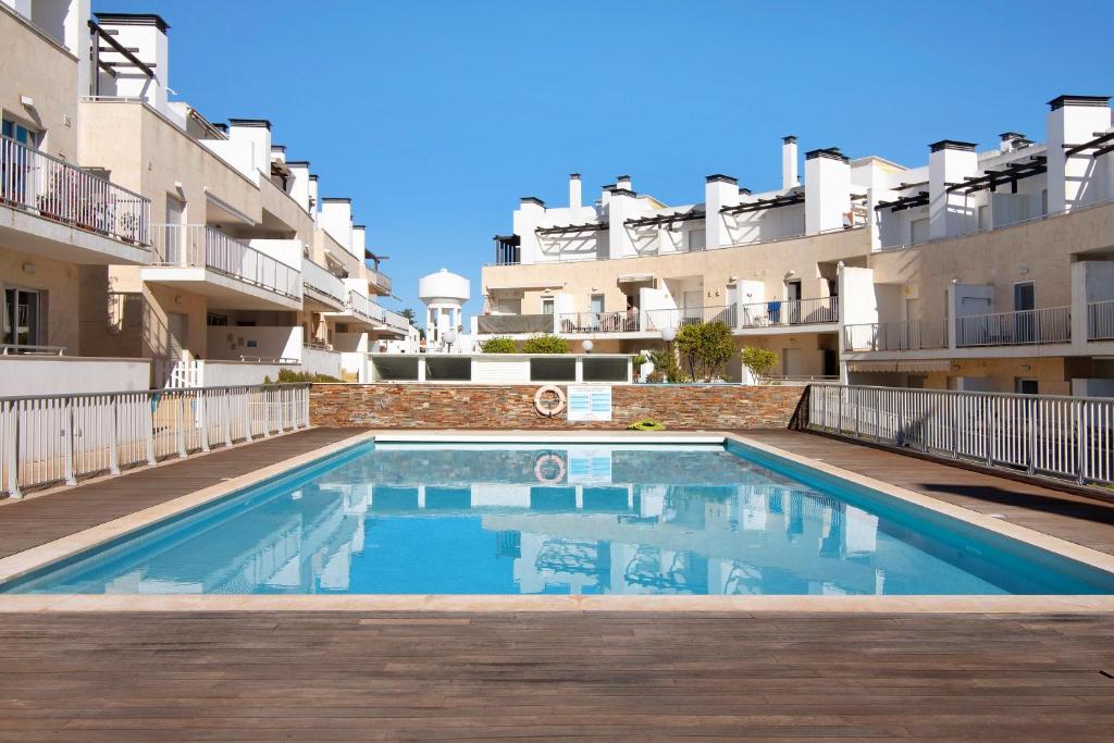 a swimming pool in front of some apartment buildings at Mare Cheia in Santa Luzia