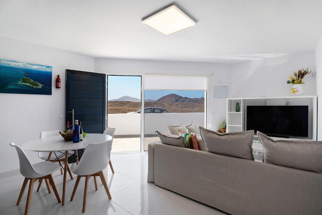 a living room with a couch and a table at Coral 5 in La Santa
