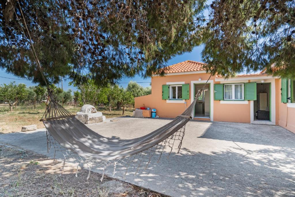 a hammock in front of a house at Avra in EFL