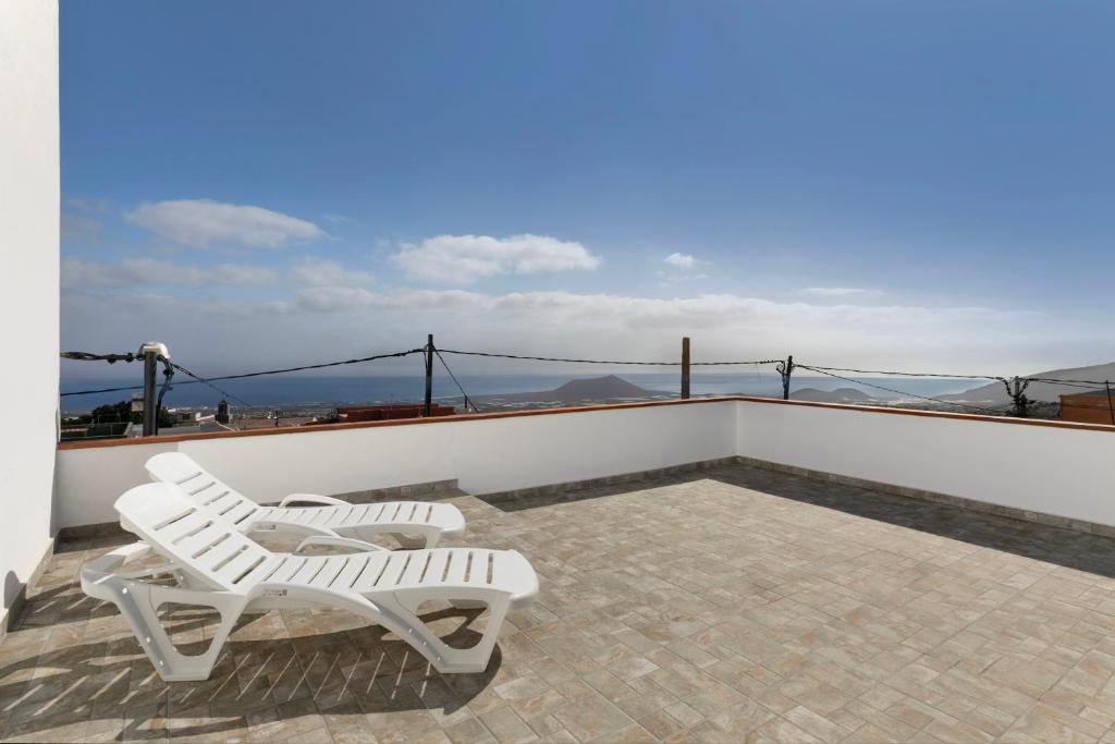 two white chairs sitting on top of a roof at Casa Otilia in Arafo