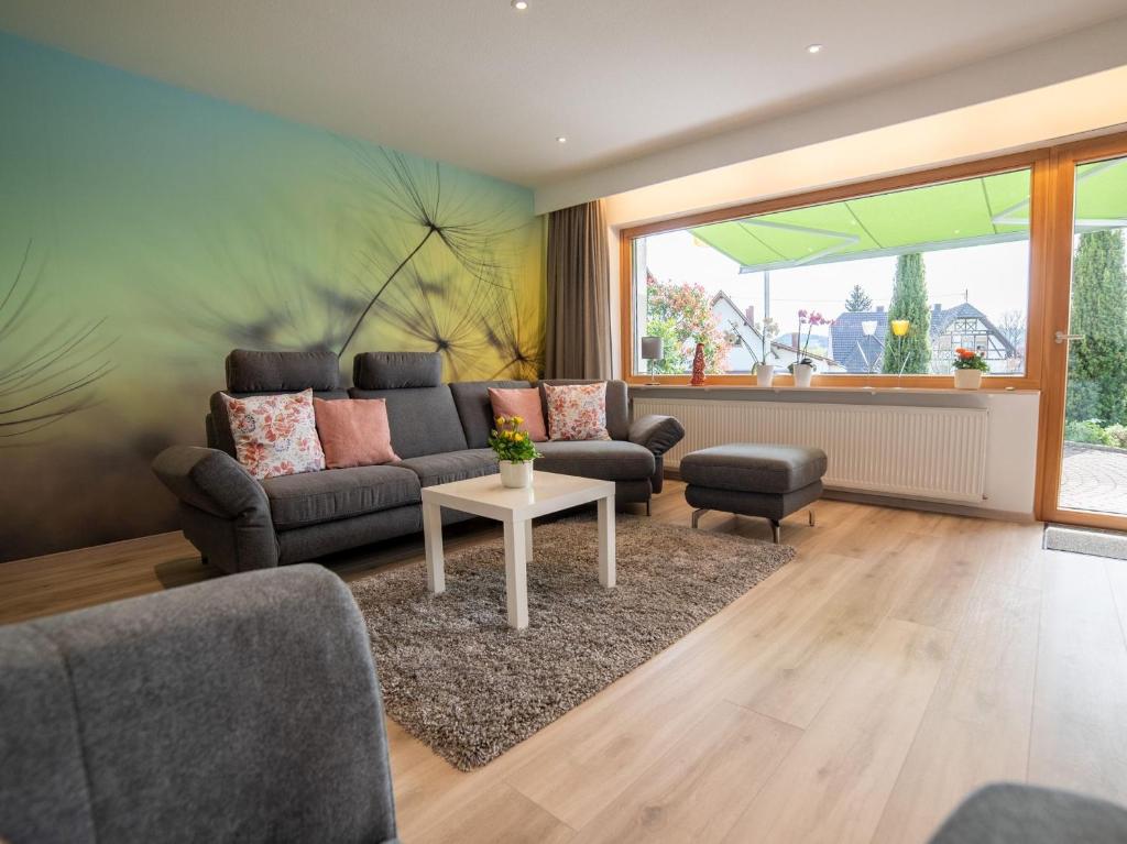 a living room with a couch and a table at Ferienwohnung Pusteblume in Kappelrodeck