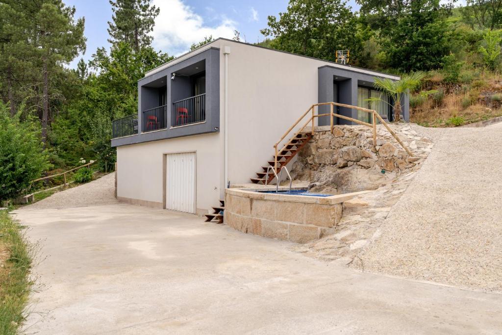 a house on the side of a hill at Felicidade in Mondim de Basto