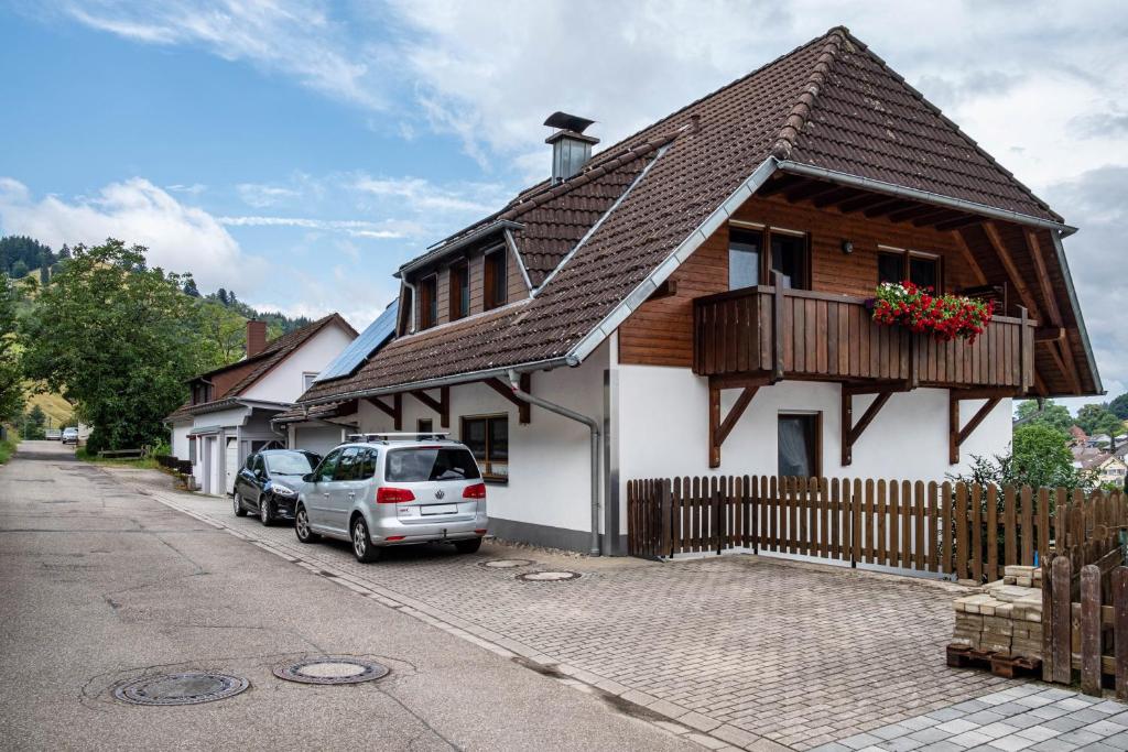 a house with cars parked on the side of a street at Haus Grünblick in Münstertal