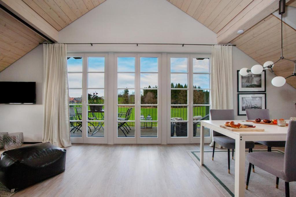 a living room with a table and chairs and a large window at Appartement in Wangen im Allgäu
