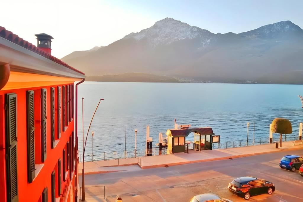 a view of a lake with cars parked at a bus stop at Elegant Central Large House F1F2 in Gravedona