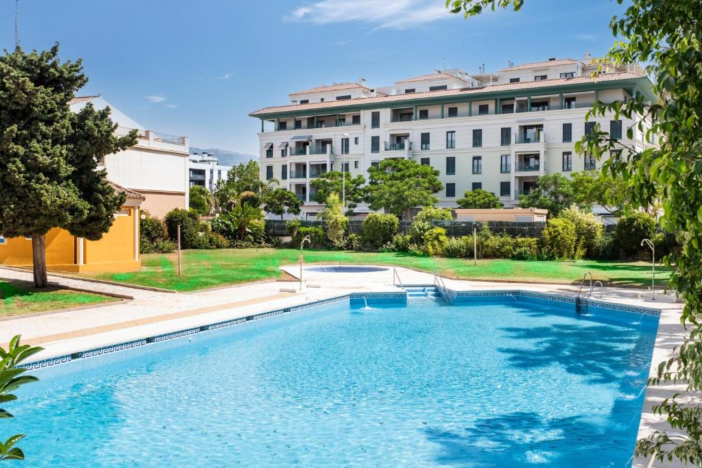 a large swimming pool in front of a building at Apartamento Sugar Factory in Torre del Mar