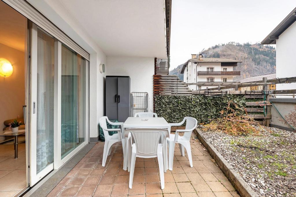 a white table and chairs on a balcony at Night and day 4 in Predazzo