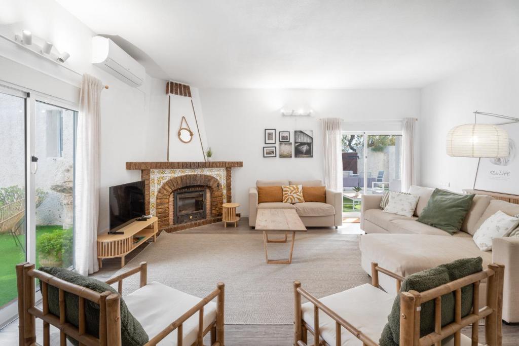 a living room with a couch and a fireplace at Chalet Saler in Valencia