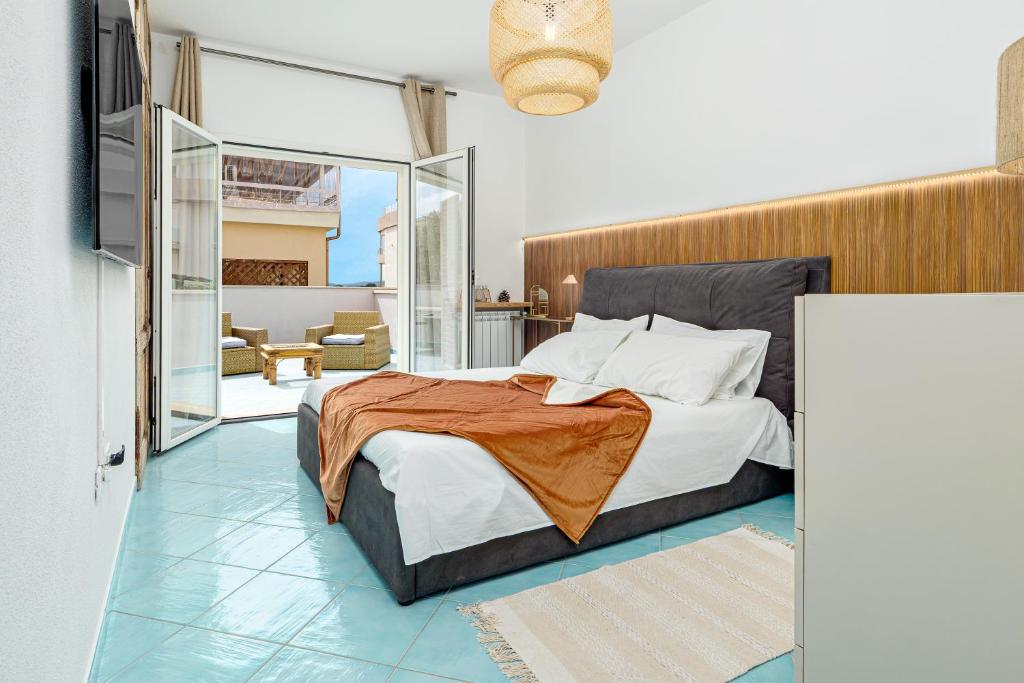 a bedroom with a bed and a living room at Colombo Apartment - by And Service in Golfo Aranci