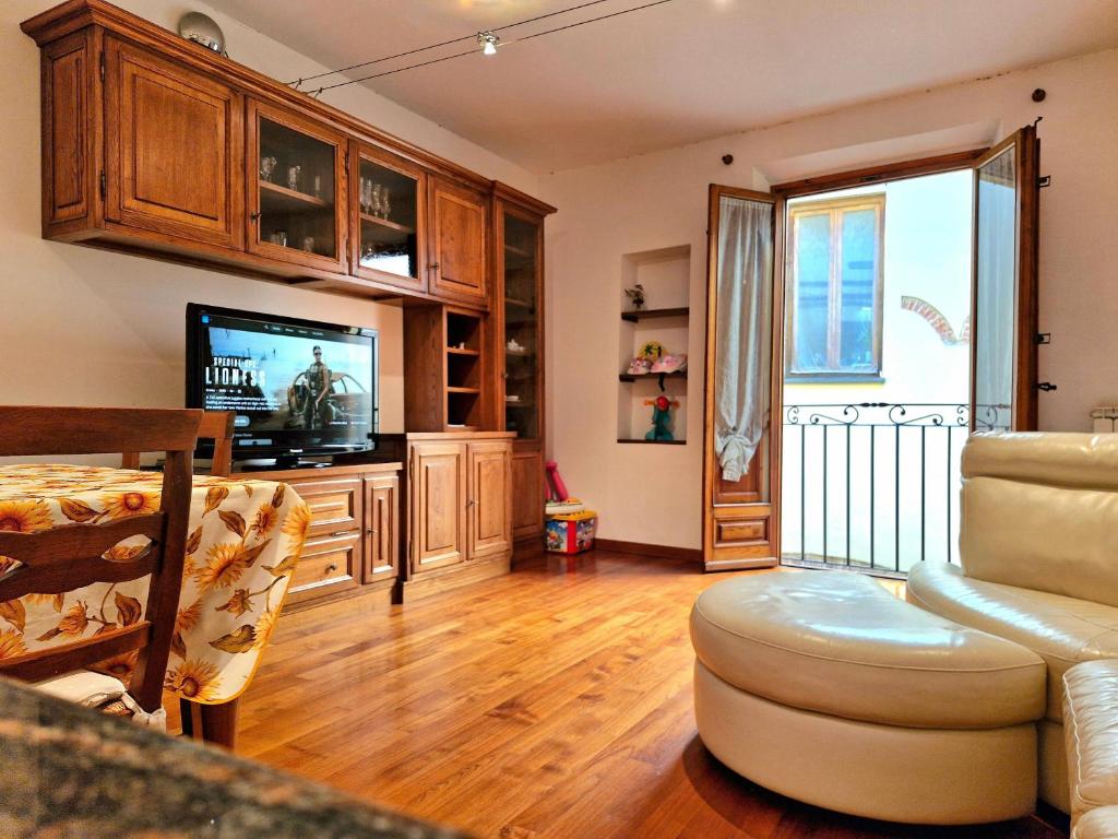 a living room with a tv and a couch at Barsotti House - Lucca in Lucca