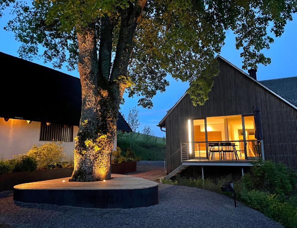 a house with a tree in front of it at Lippenhof - Unter der Linde in Unterkirnach