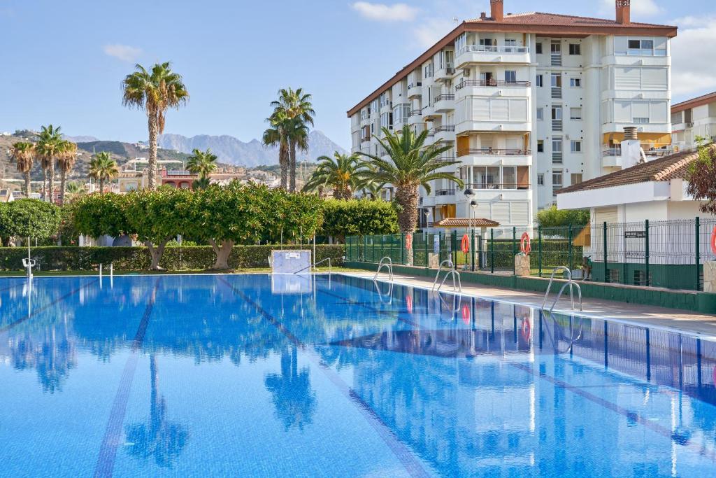 a large swimming pool in front of a building at La Mejor in Torrox